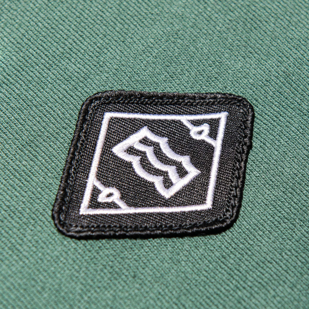 close up of wave logo in diamond design on pocket 
