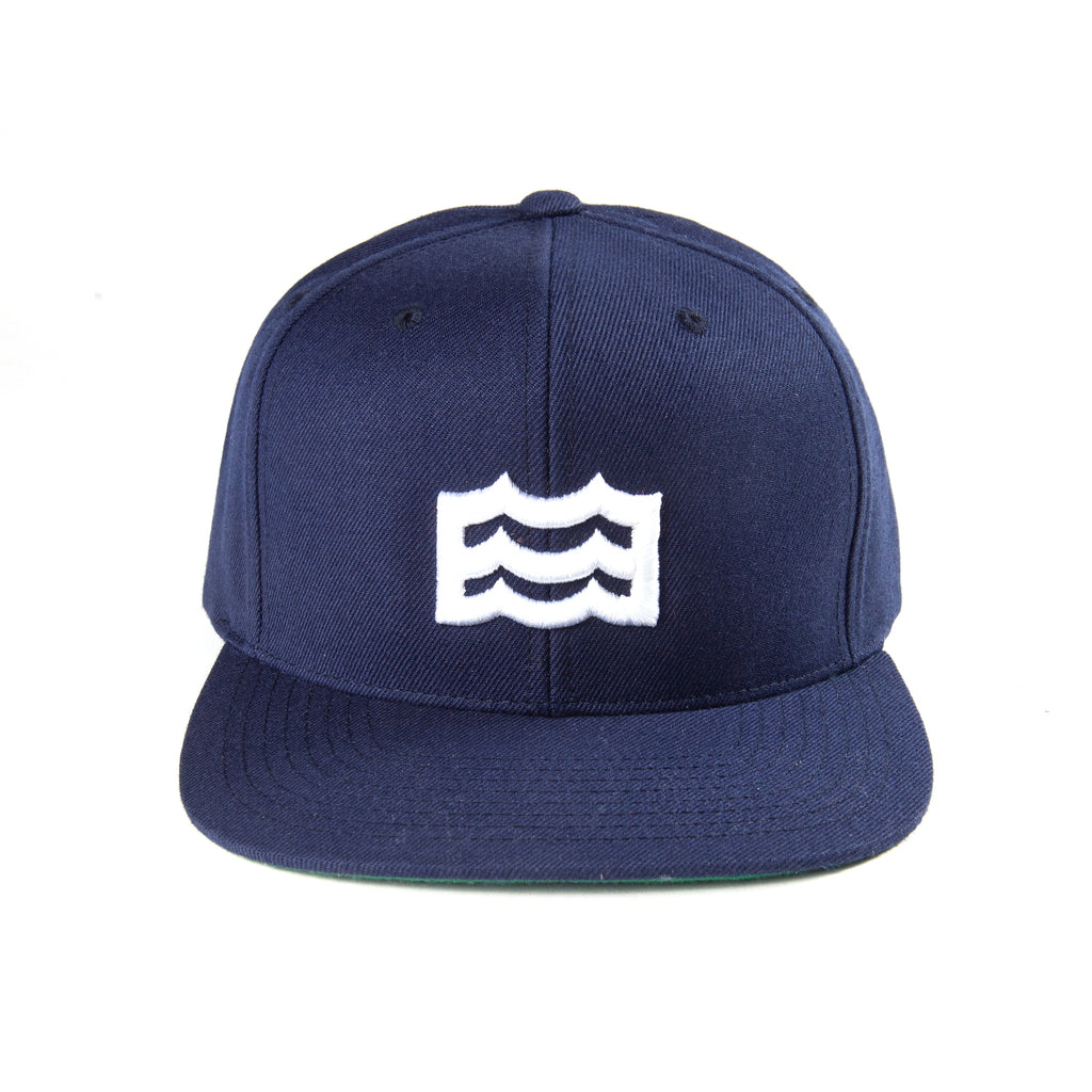 navy snapback with white woven wave logo